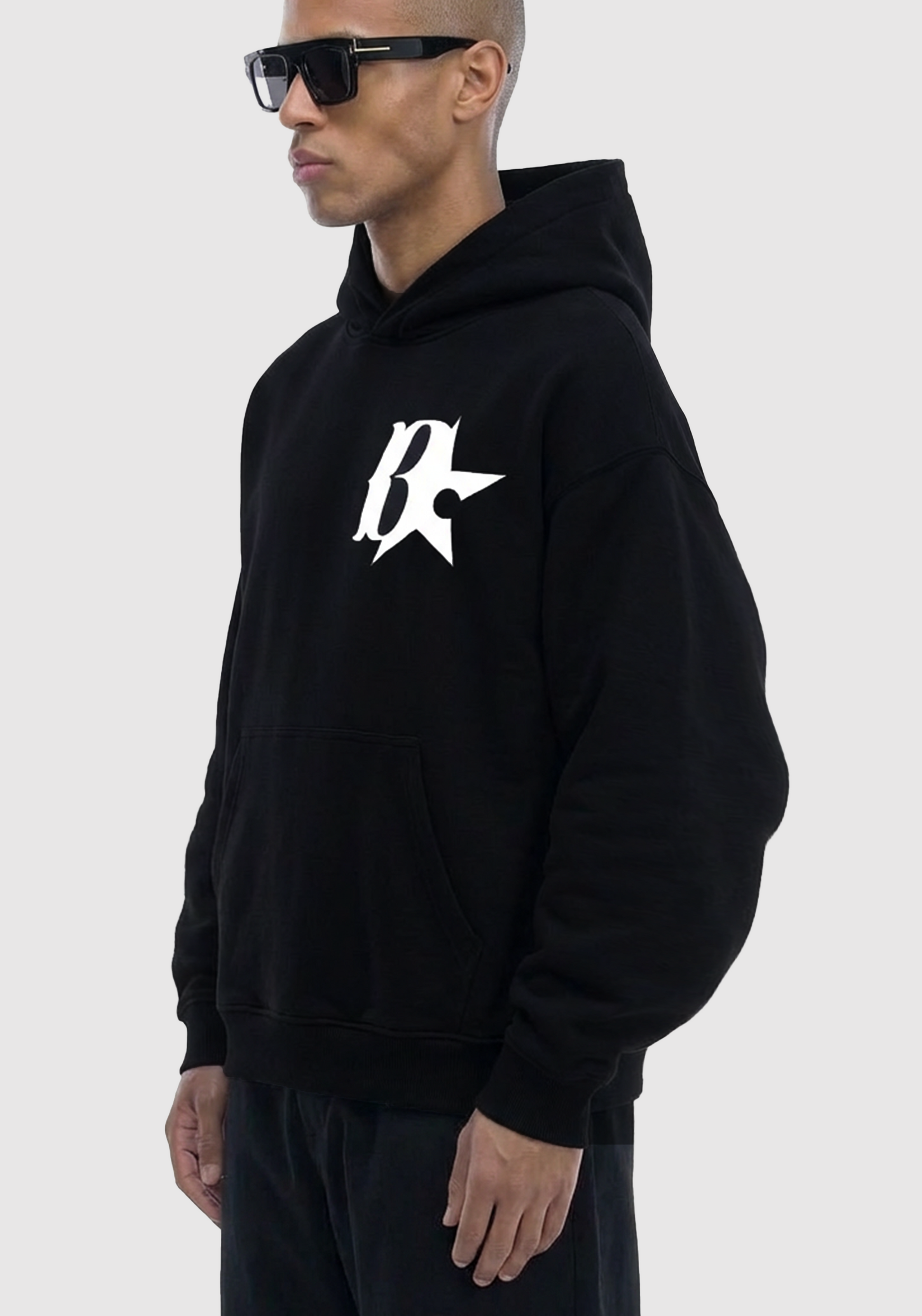 model wearing a black hoodie with a logo on a white background
