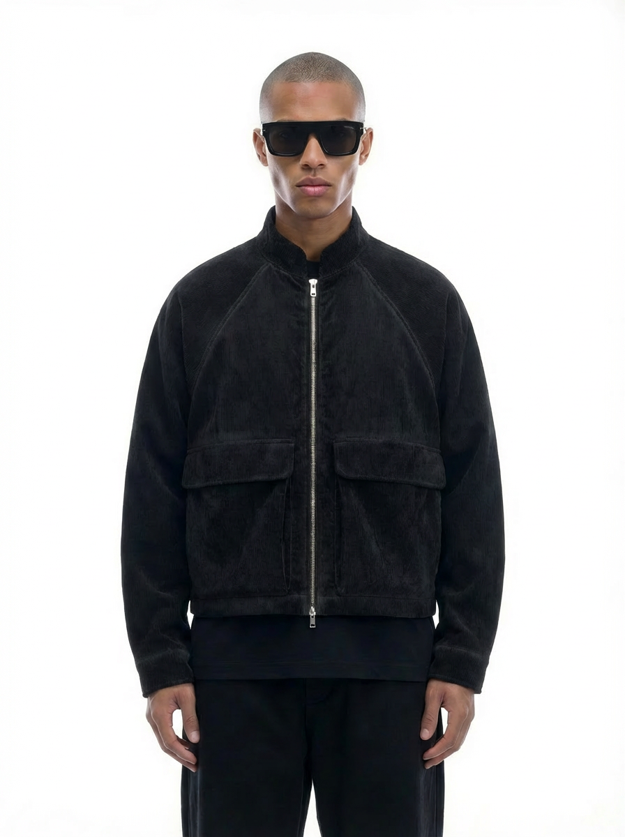 Man wearing a black back and forth jacket and sunglasses on a white background